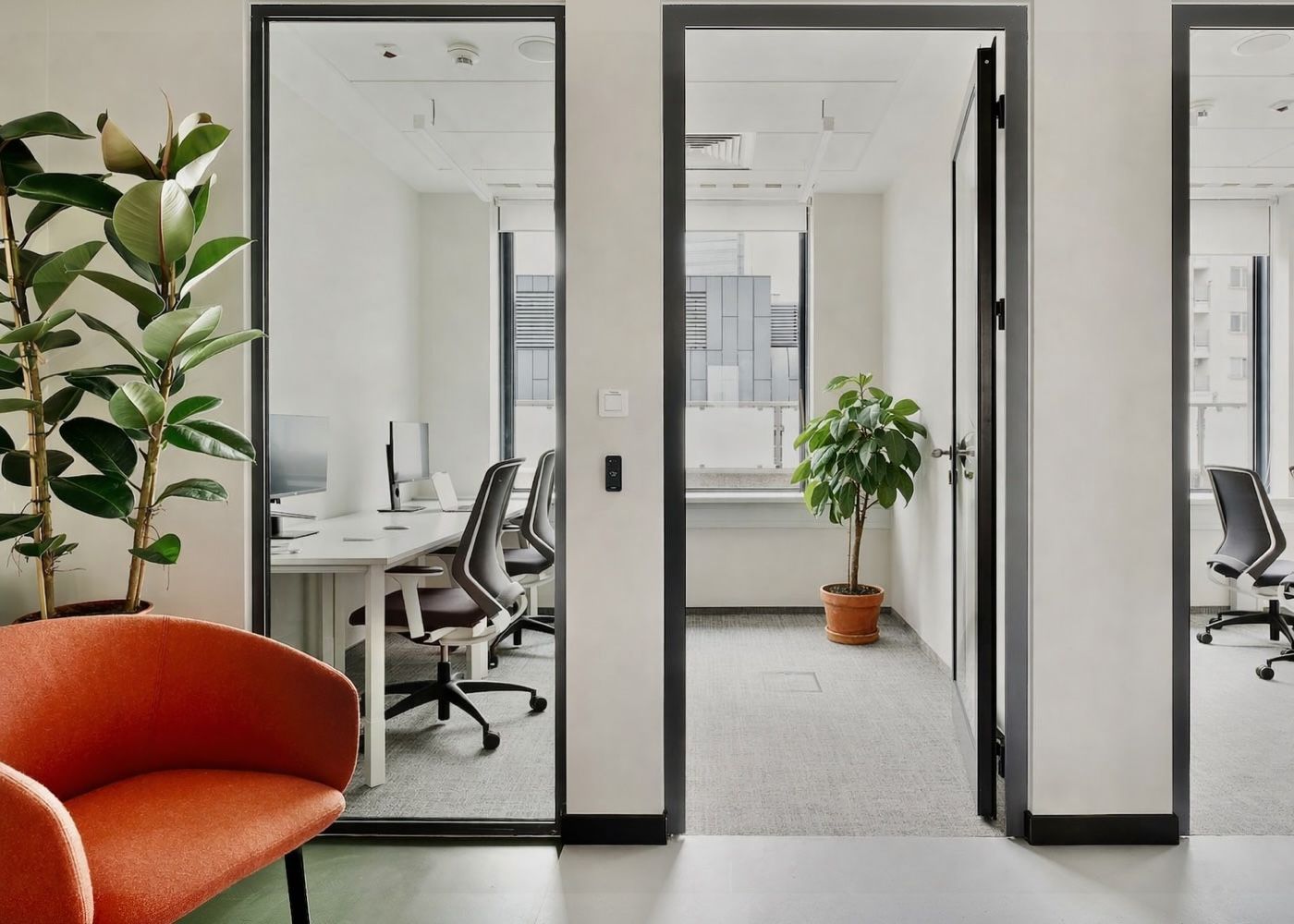 Glass-walled private offices at a Cluster coworking location